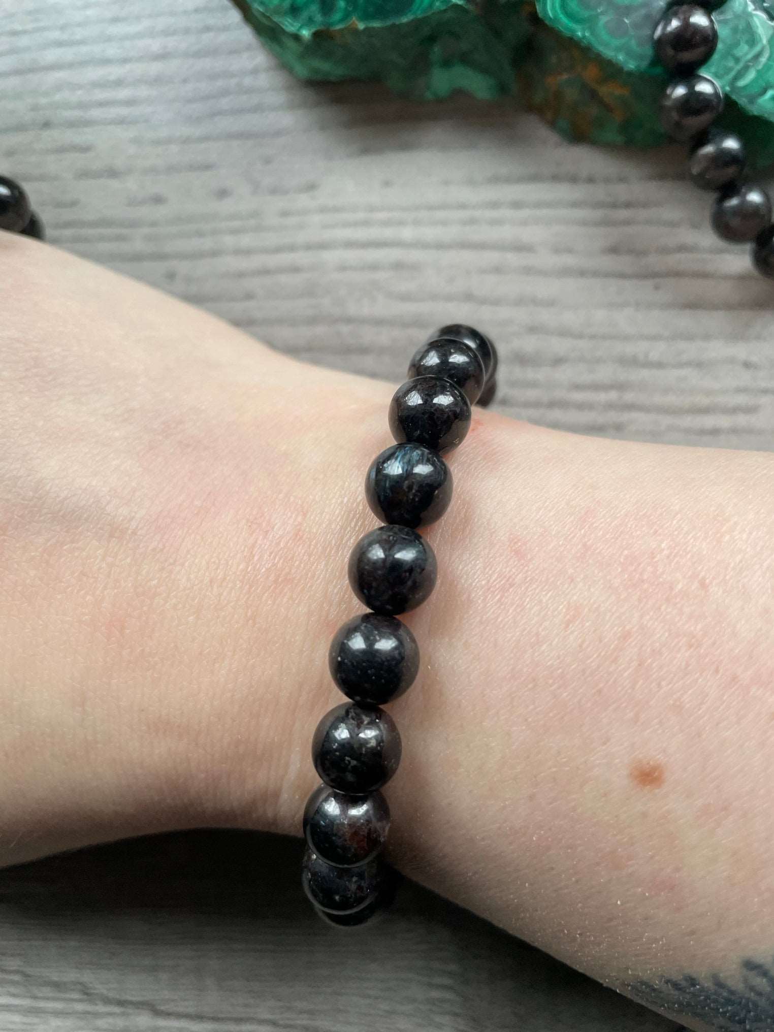 Pictured is an arfvedsonite bead bracelet.