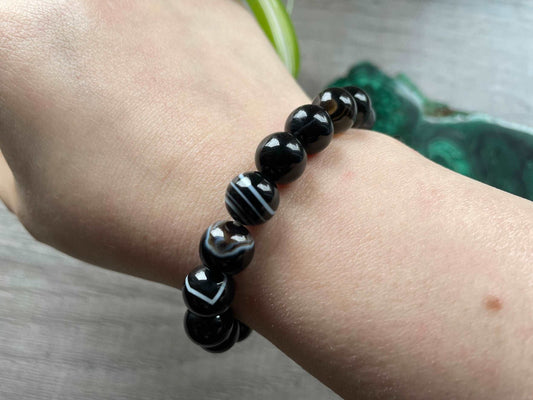 Pictured is a black agate bead bracelet.