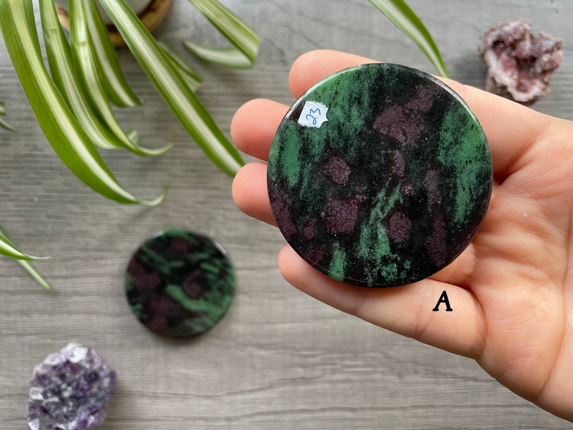 Pictured is a ruby in zoisite crystal coin.