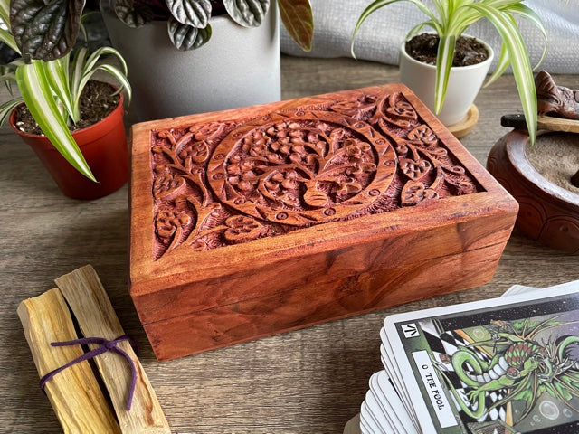 Pictured is hand-carved wood box with a tree of life in the middle.