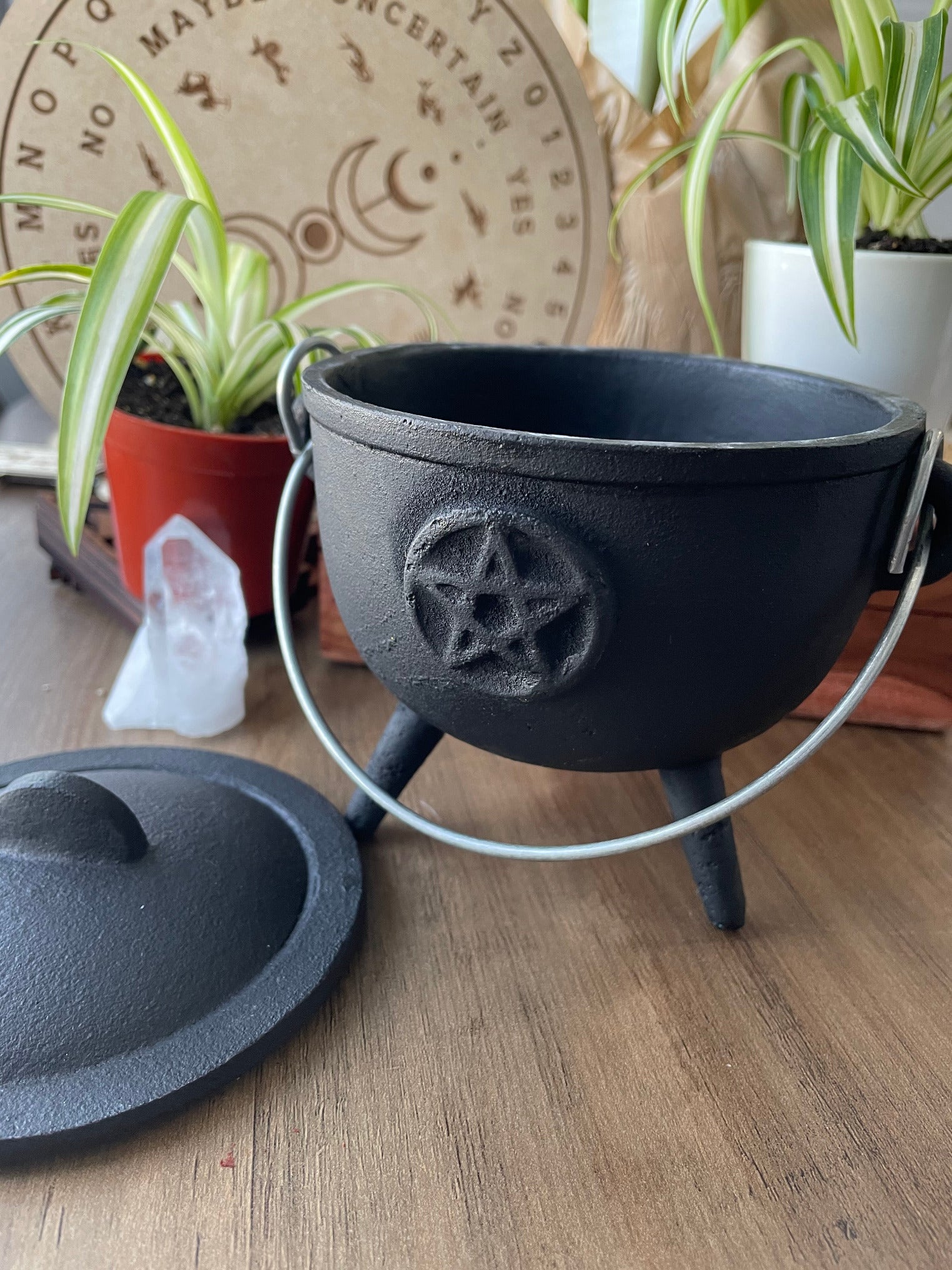 Pictured is a cast iron cauldron with lid.