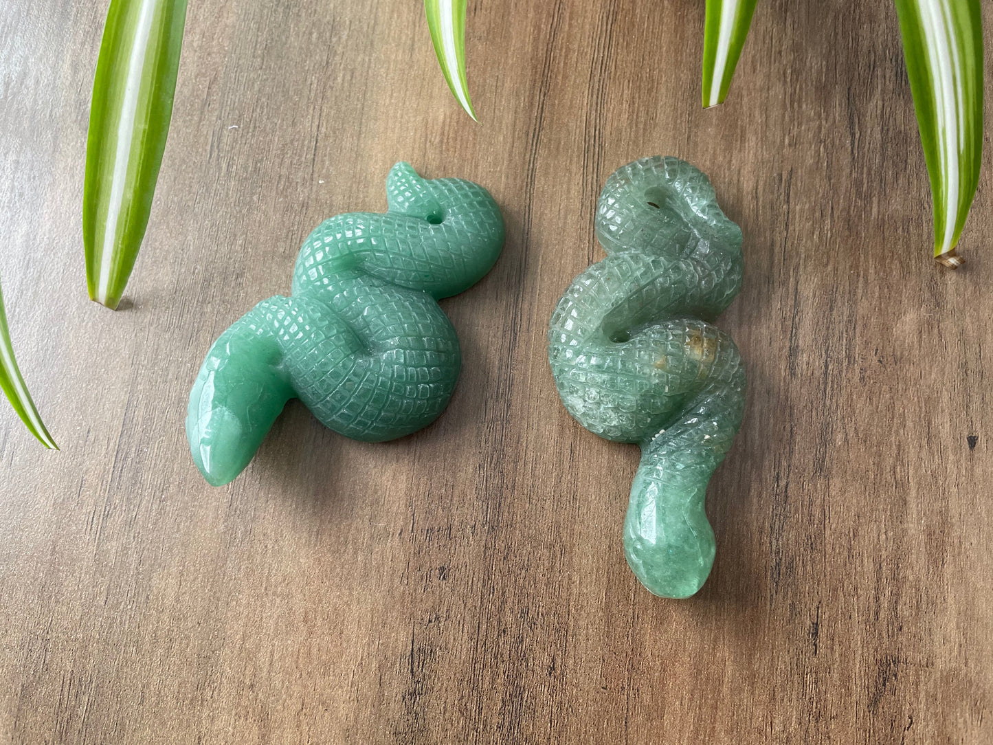 Pictured is a snake or serpent carved out of green aventurine.