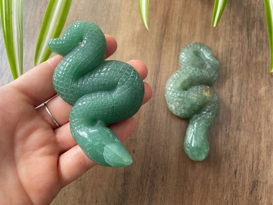Pictured is a snake or serpent carved out of green aventurine.