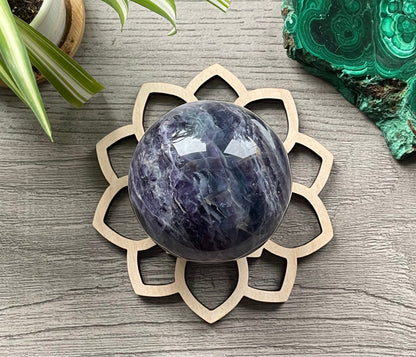 Pictured is a wood sphere stand in the shape of a flower.