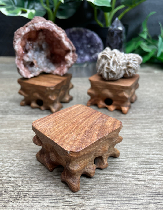 Pictured are various wood crystal specimen stands.
