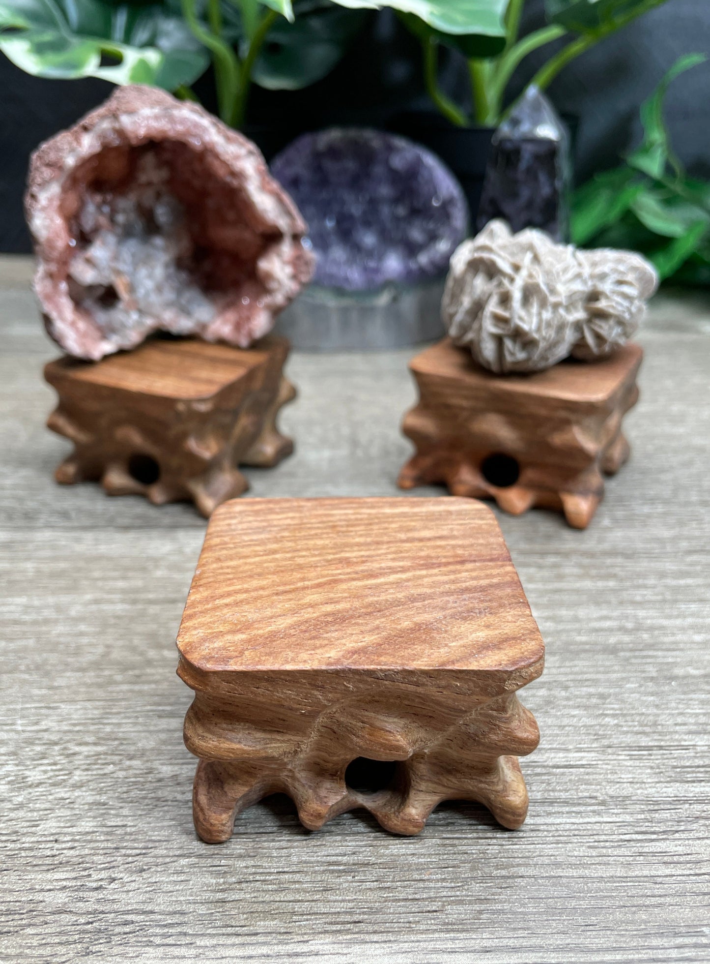 Pictured are various wood crystal specimen stands.