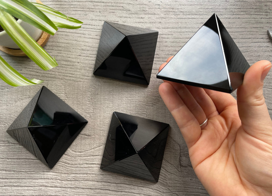 Pictured are four black obsidian pyramids.