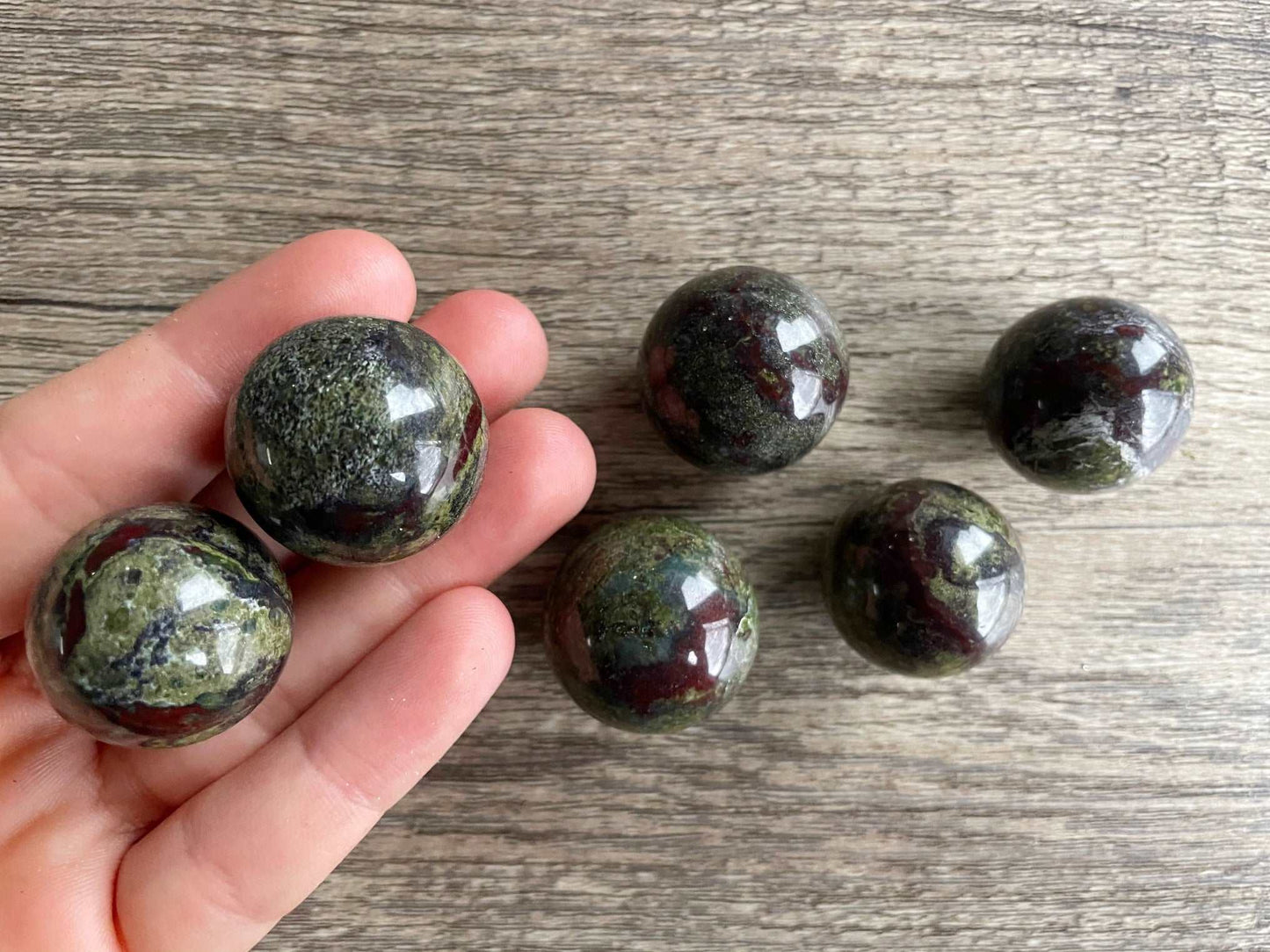 Pictured is a sphere carved out of dragon bloodstone.