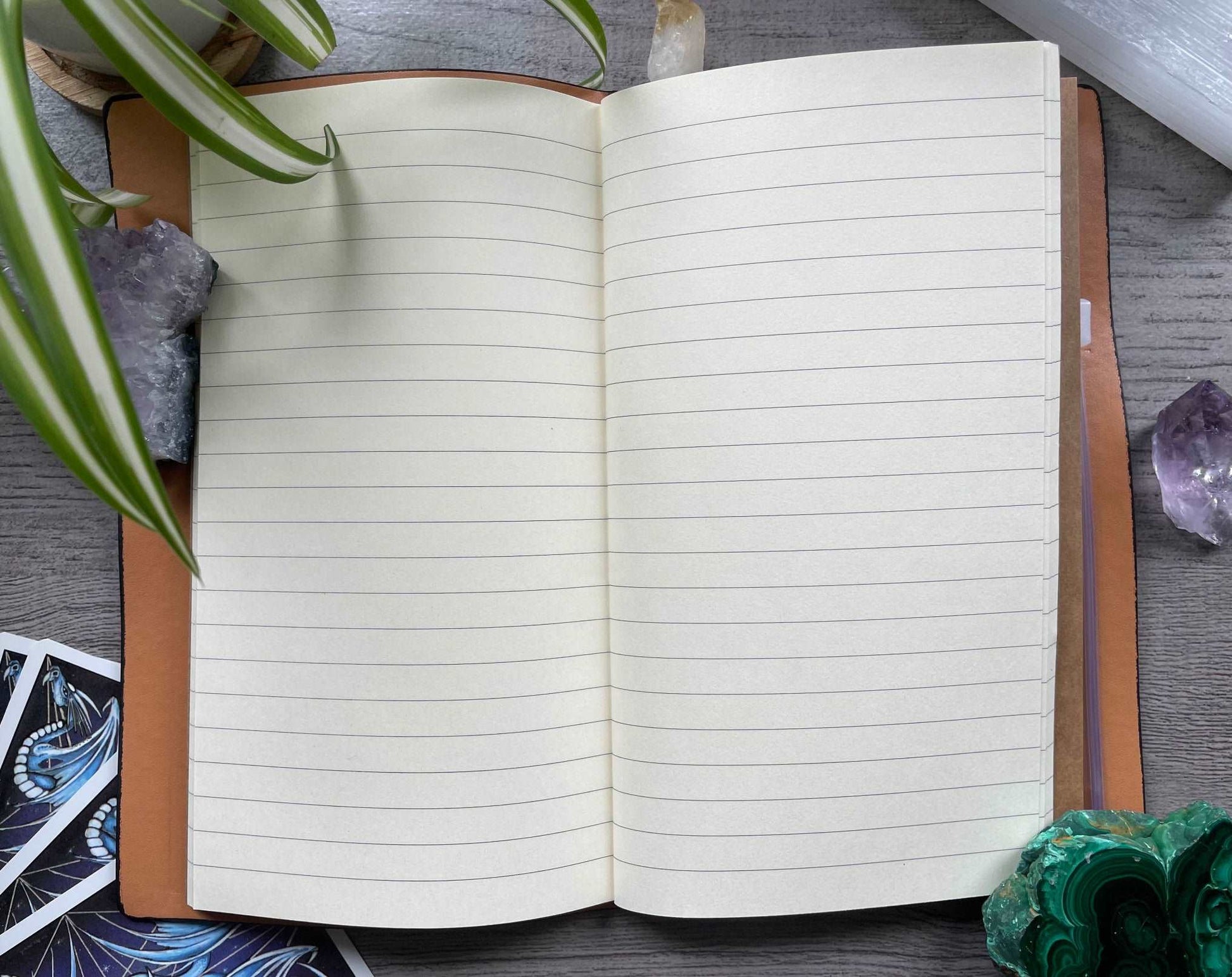 Pictured is a faux leather refillable notebook with a crystal.