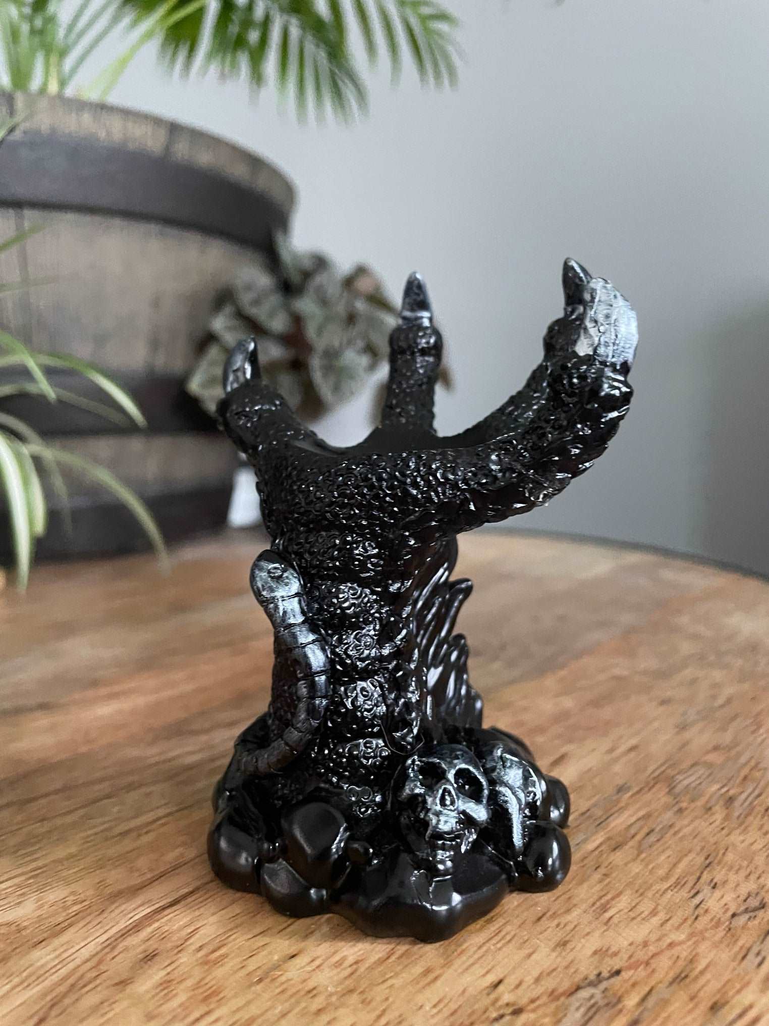 Pictured is a sphere stand in the shape of a black dragon's claw.