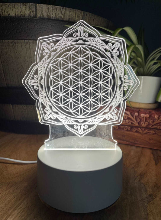 Pictured is a night light with an acrylic flower of life design.