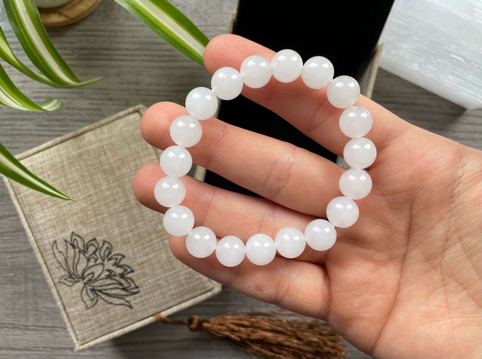 Pictured is a genuine, high-quality white jade bead bracelet.