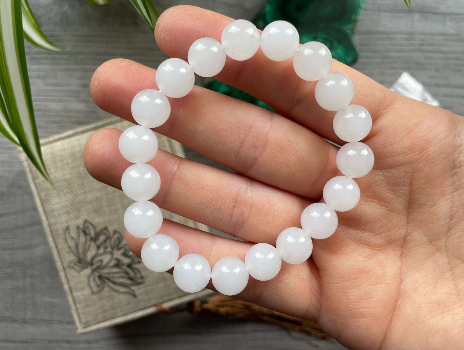 Pictured is a genuine, high-quality white jade bead bracelet.