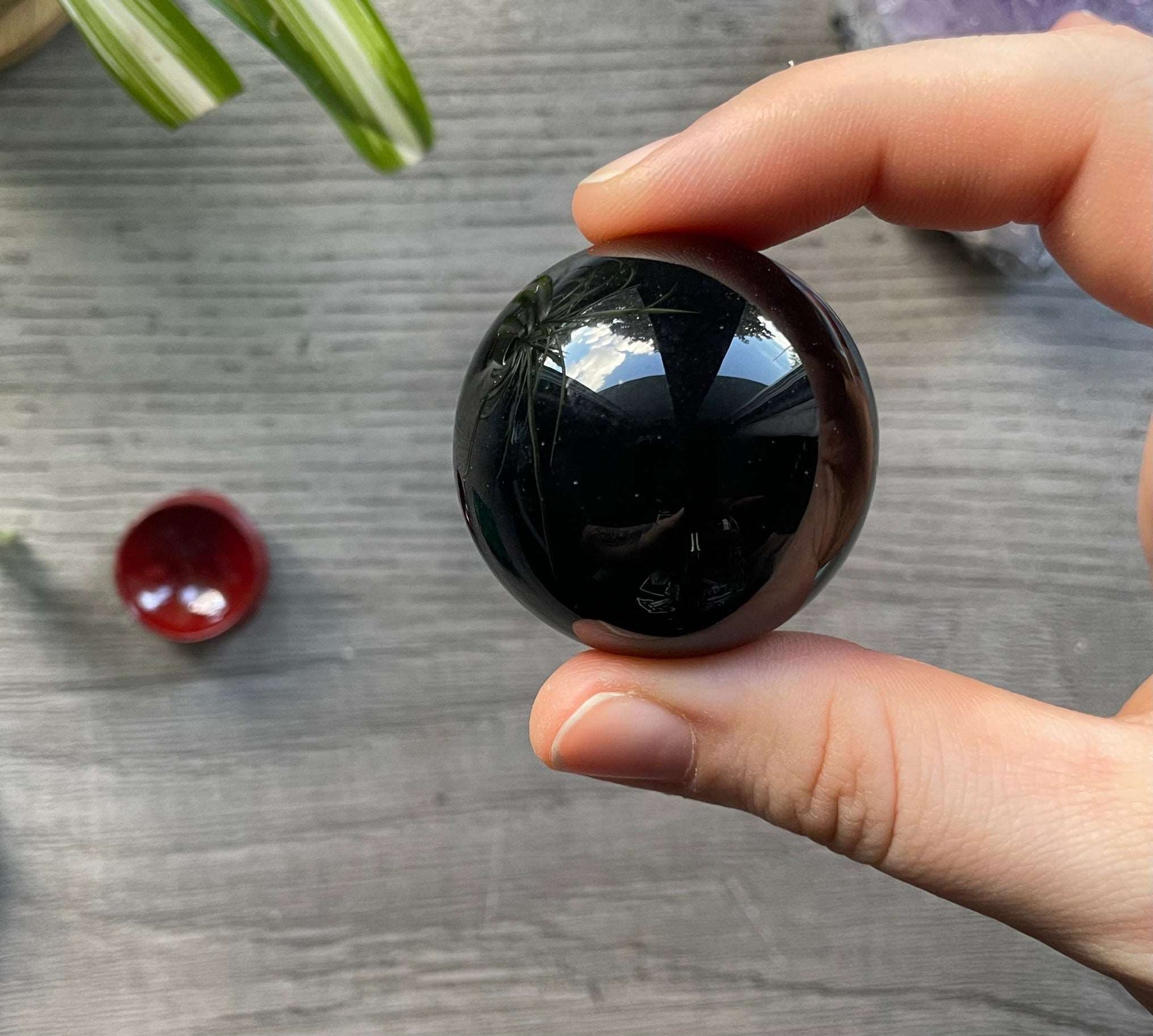 Pictured is a sphere carved out of black obsidian.