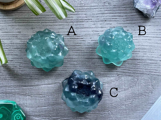 Pictured are various lotus flowers carved out of blue fluorite.