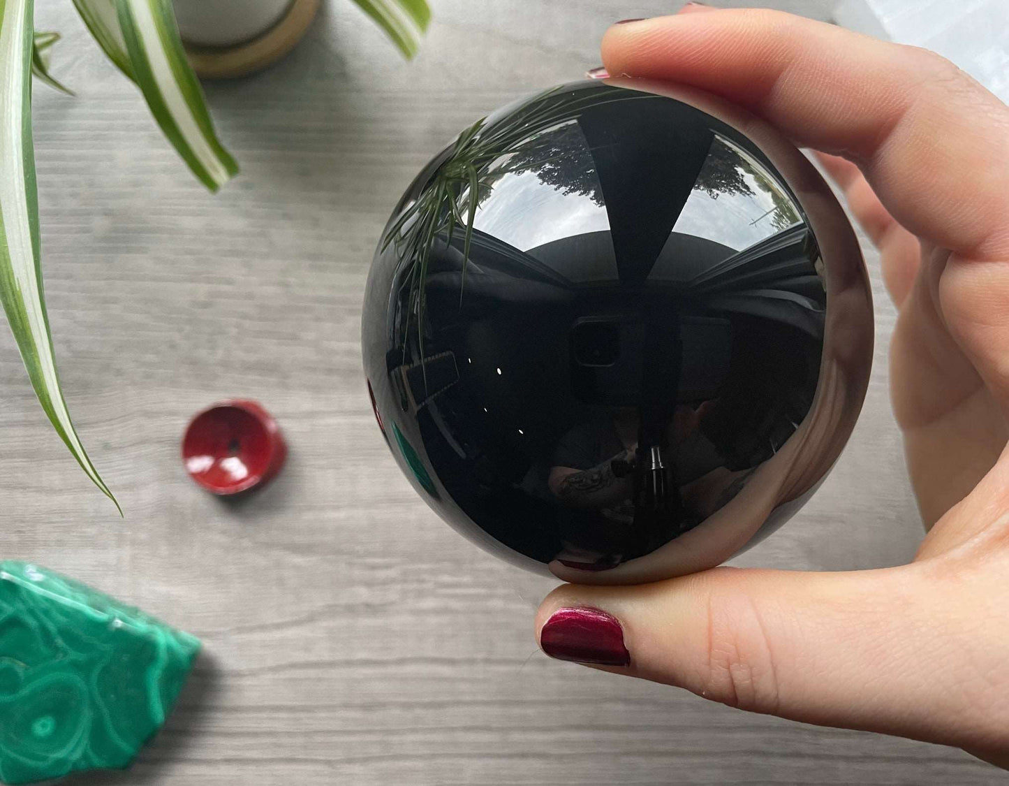 Pictured is a sphere carved out of black obsidian.