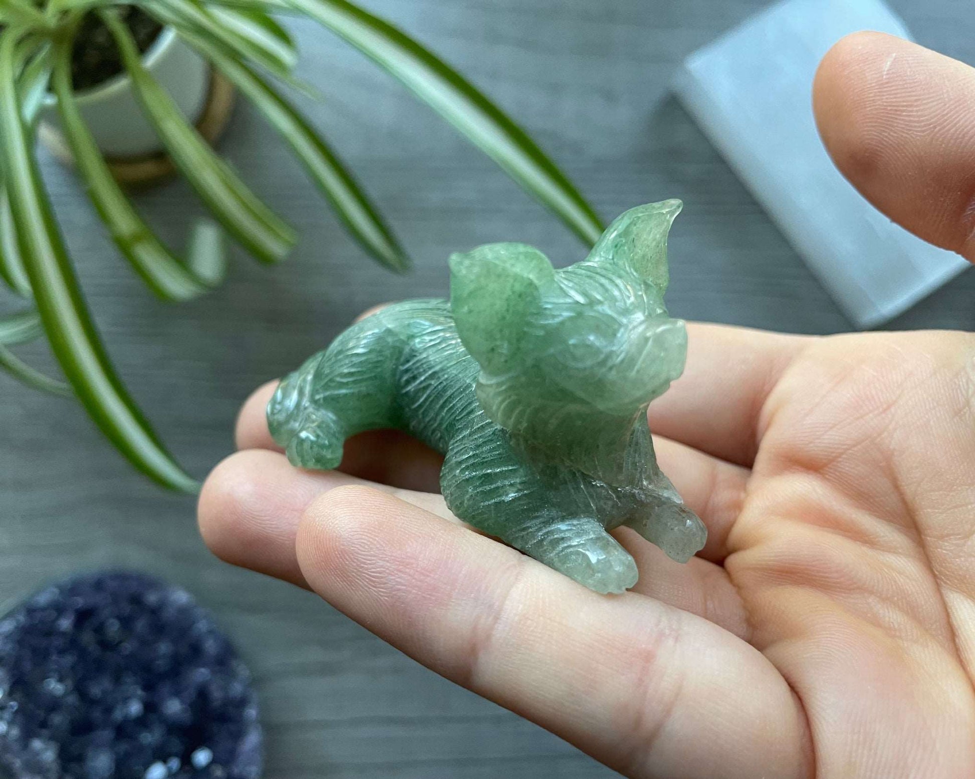Pictured is a green aventurine dog carving.