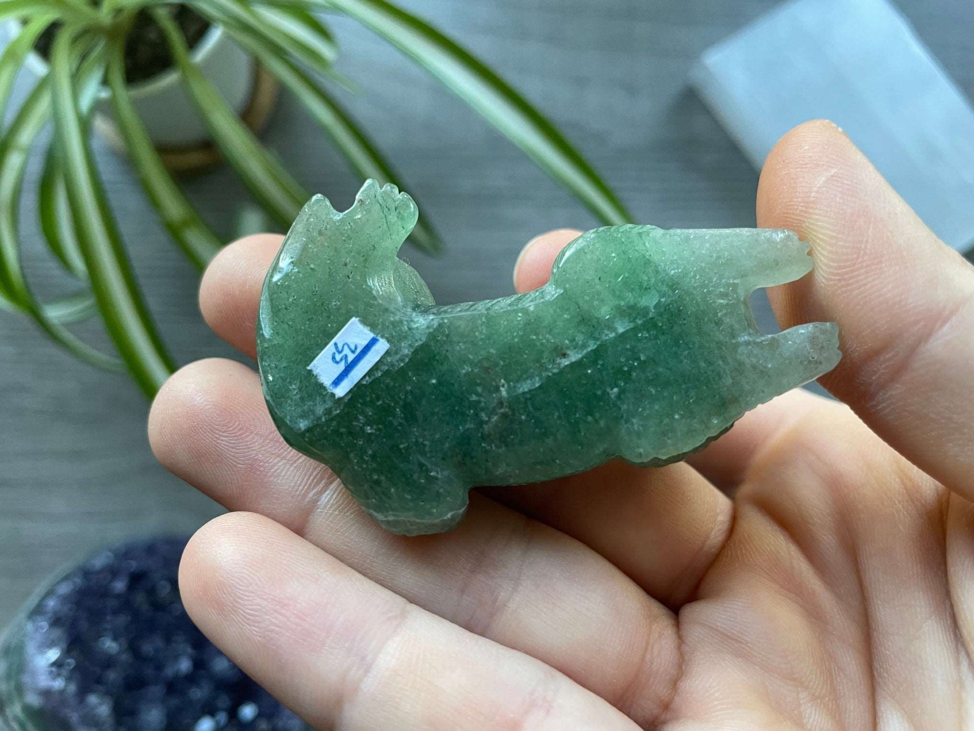 Pictured is a green aventurine dog carving.