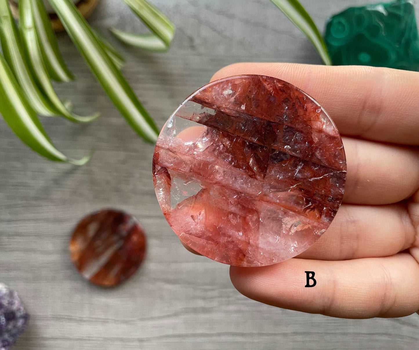 Pictured is a fire quartz crystal coin.