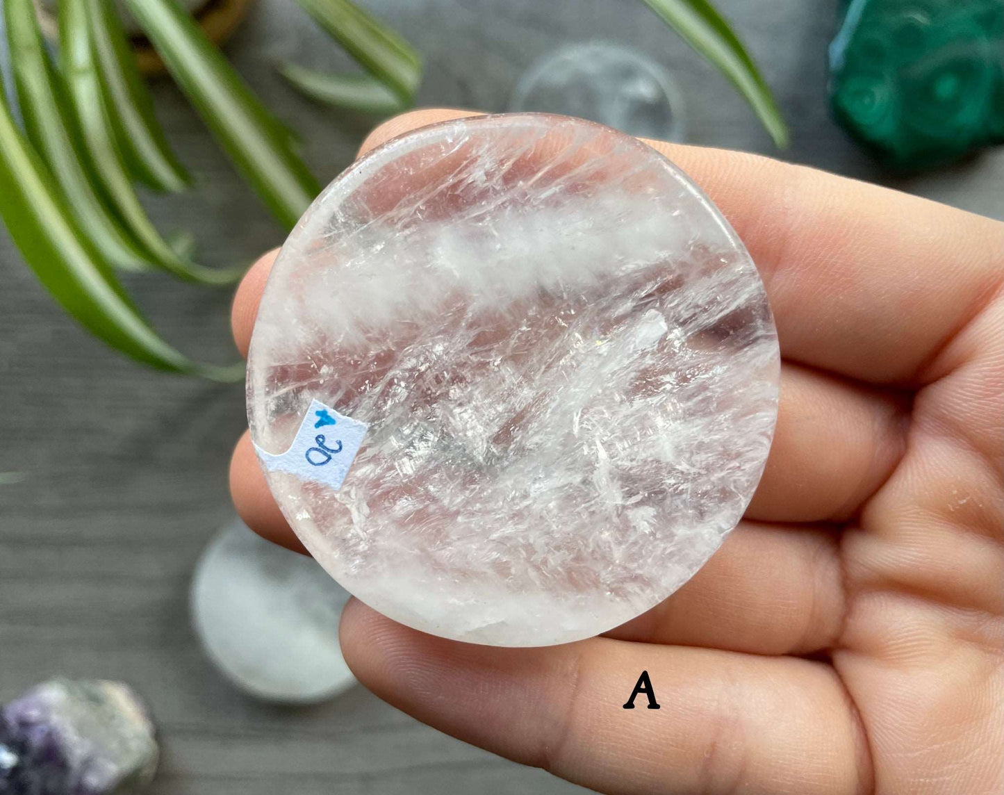 Pictured is a clear quartz crystal coin.
