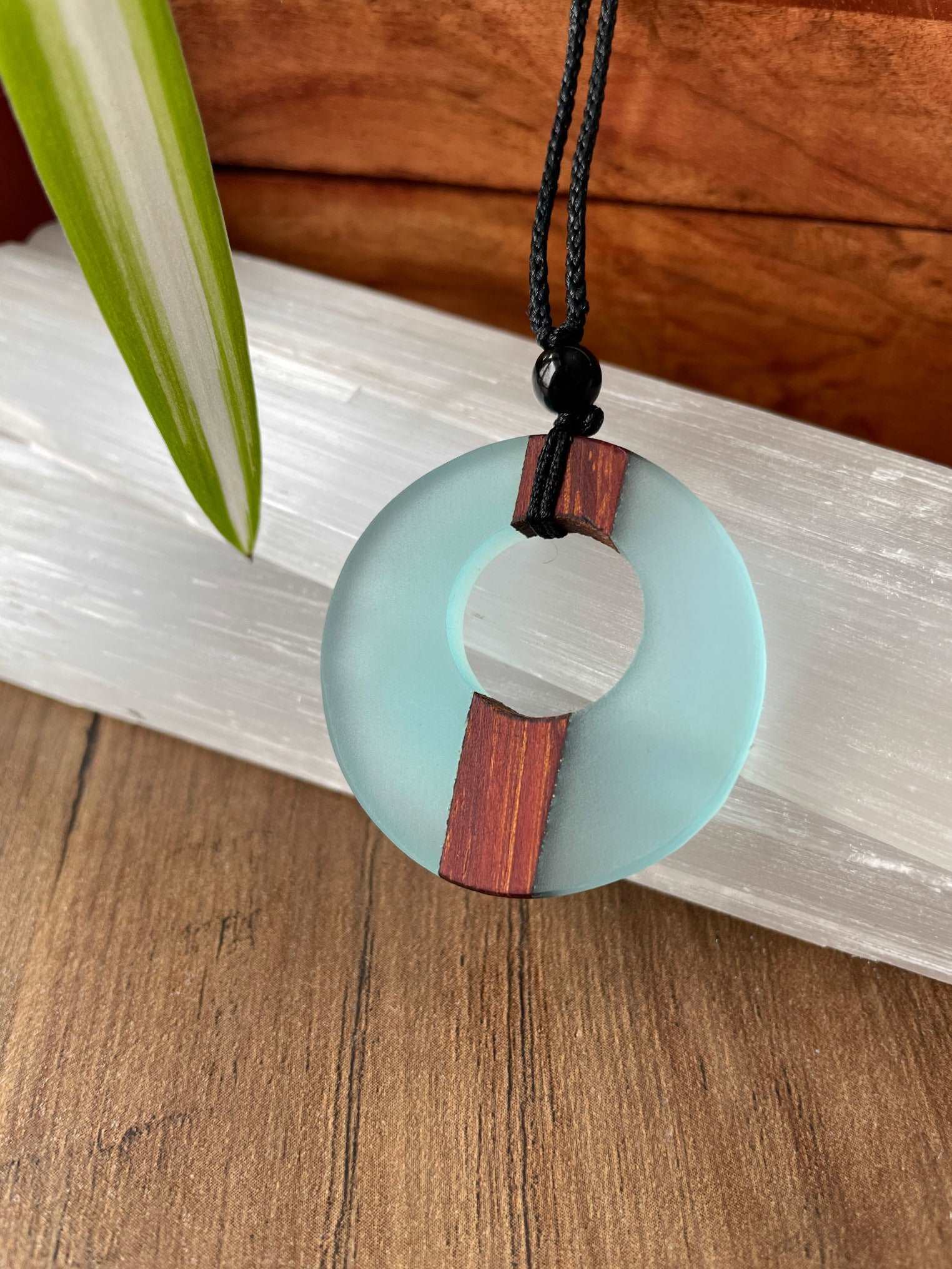 Pictured is a necklace made of wood and resin.