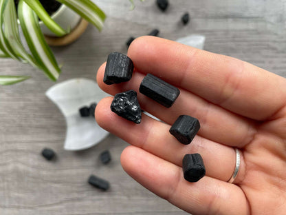 Pictured are pieces of raw black tourmaline.