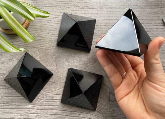 Pictured are various pyramids carved out of black obsidian.
