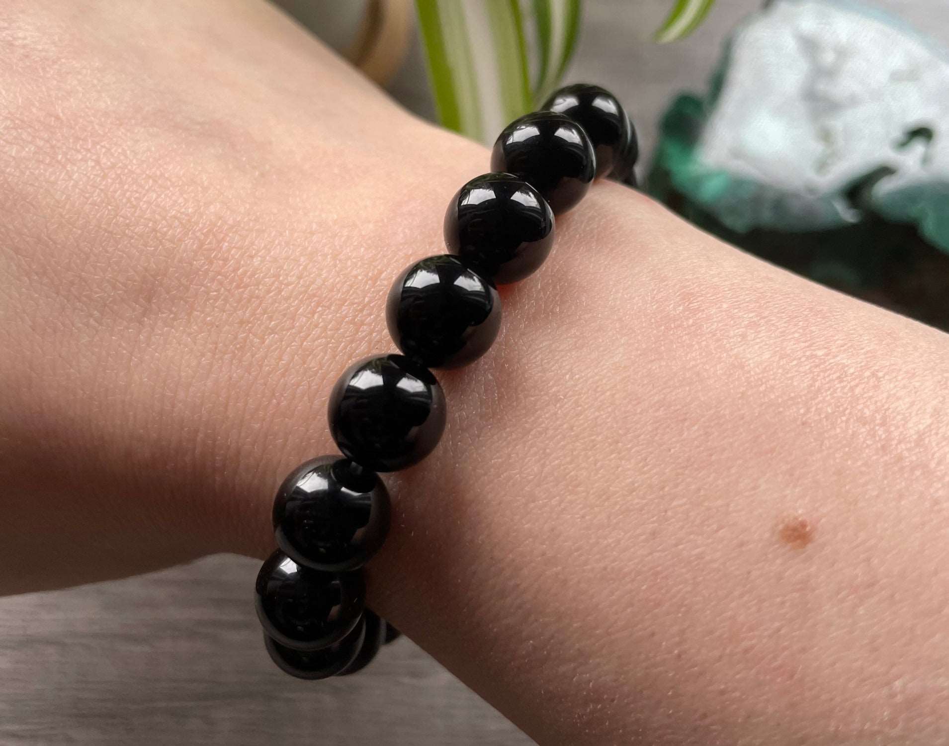 Pictured is a black obsidian bead bracelet.