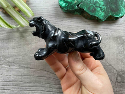 Pictured is a tiger carved out of black obsidian.