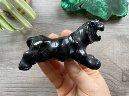 Pictured is a tiger carved out of black obsidian.