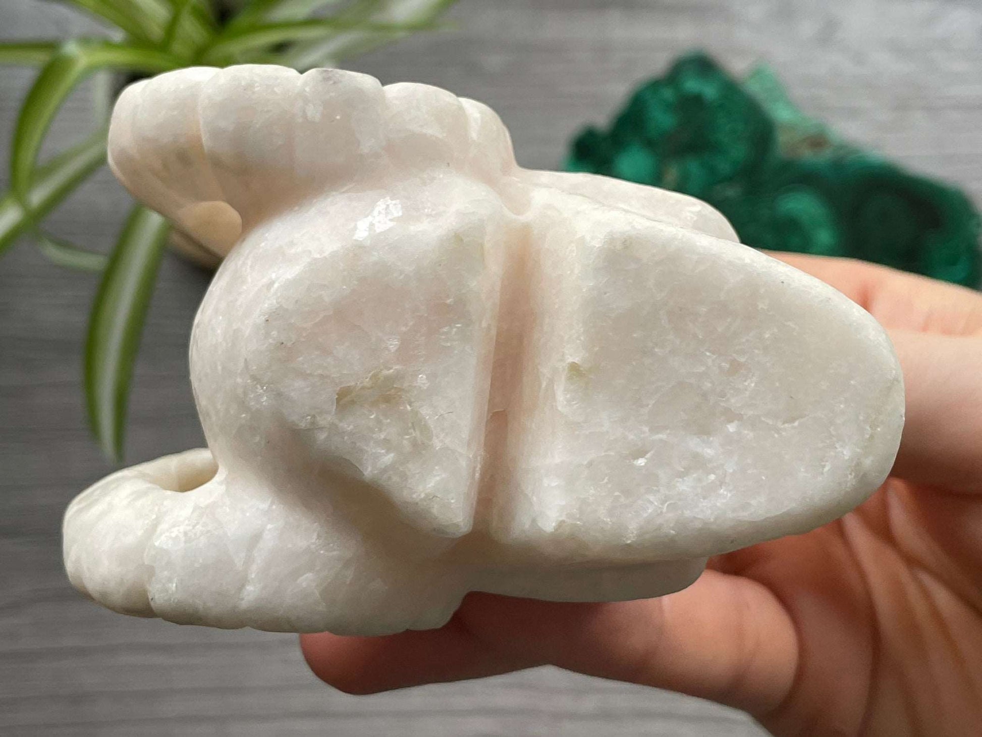 Pictured is a demon skull with horns carved out of white calcite.