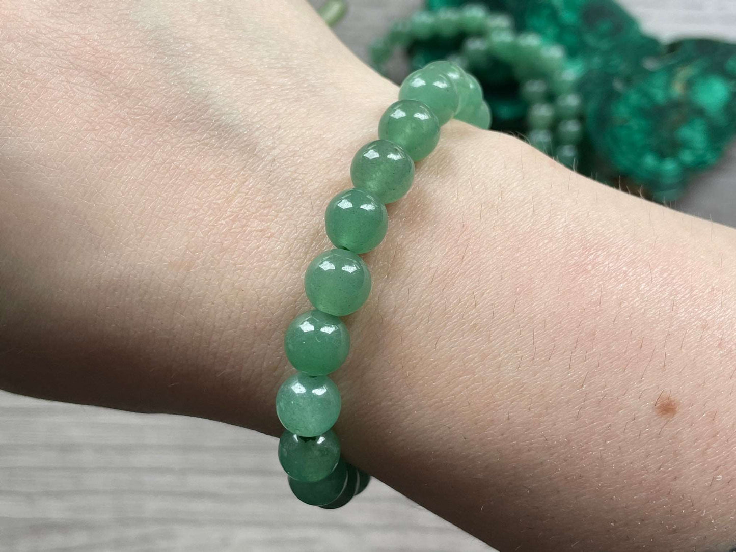 Pictured is a green aventurine bead bracelet.