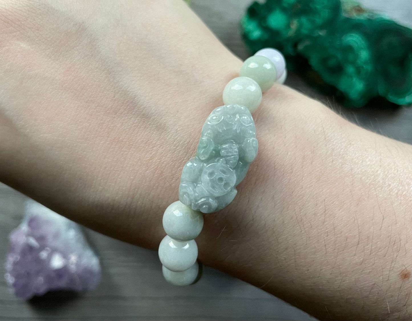 Pictured is a genuine Hetian jade bead bracelet with a large jade bead in the shape of Pixiu in the middle.