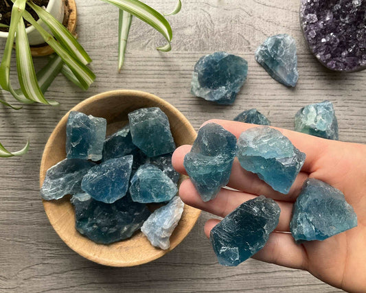 Pictured are various pieces of raw blue fluorite.