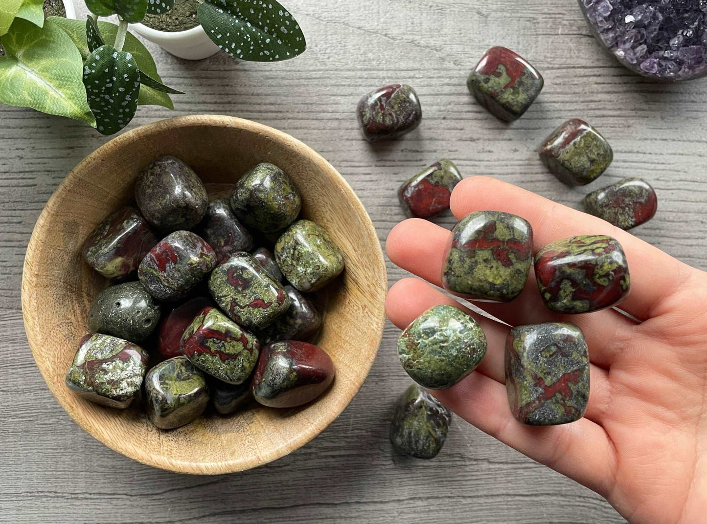 Pictured are various dragon bloodstone tumbled stones.
