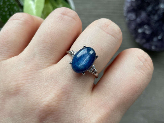 Pictured is a blue kyanite gemstone set in an S925 sterling silver ring.