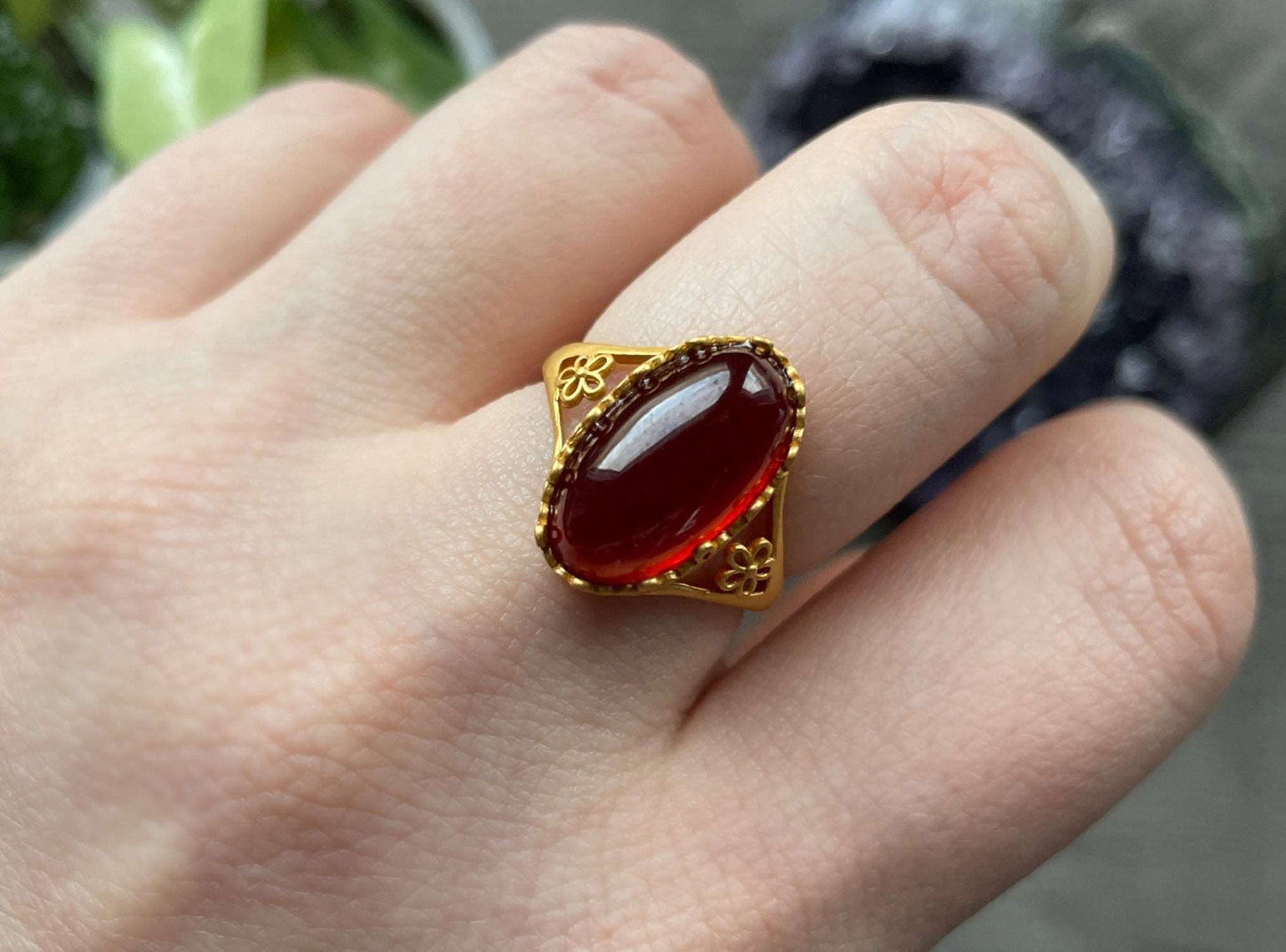 Pictured is a garnet gemstone set in an S925 sterling silver ring.