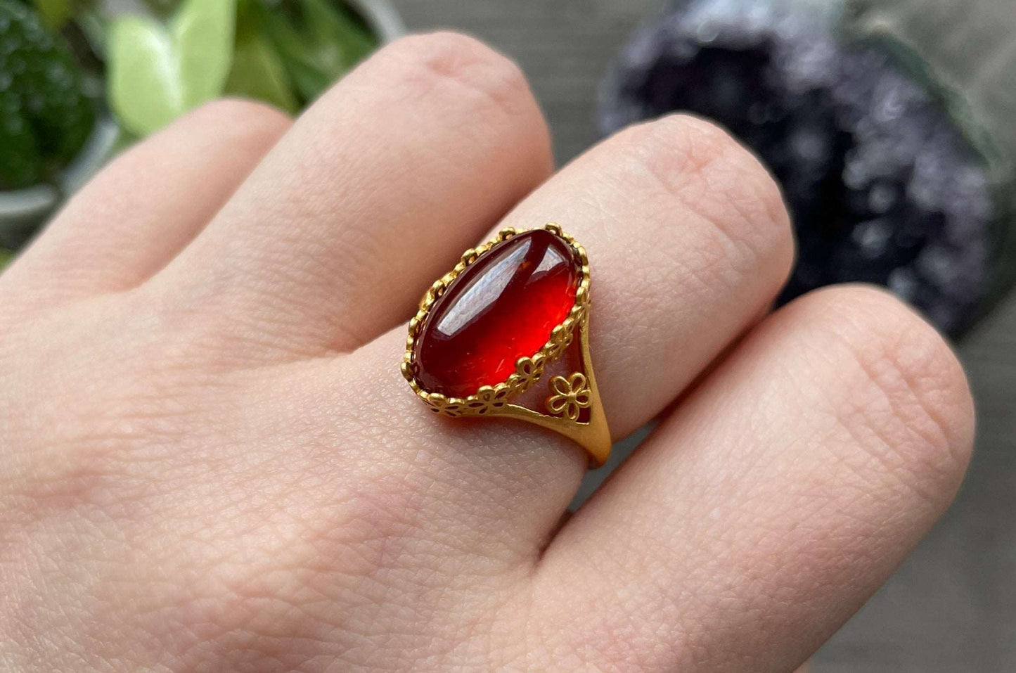 Pictured is a garnet gemstone set in an S925 sterling silver ring.