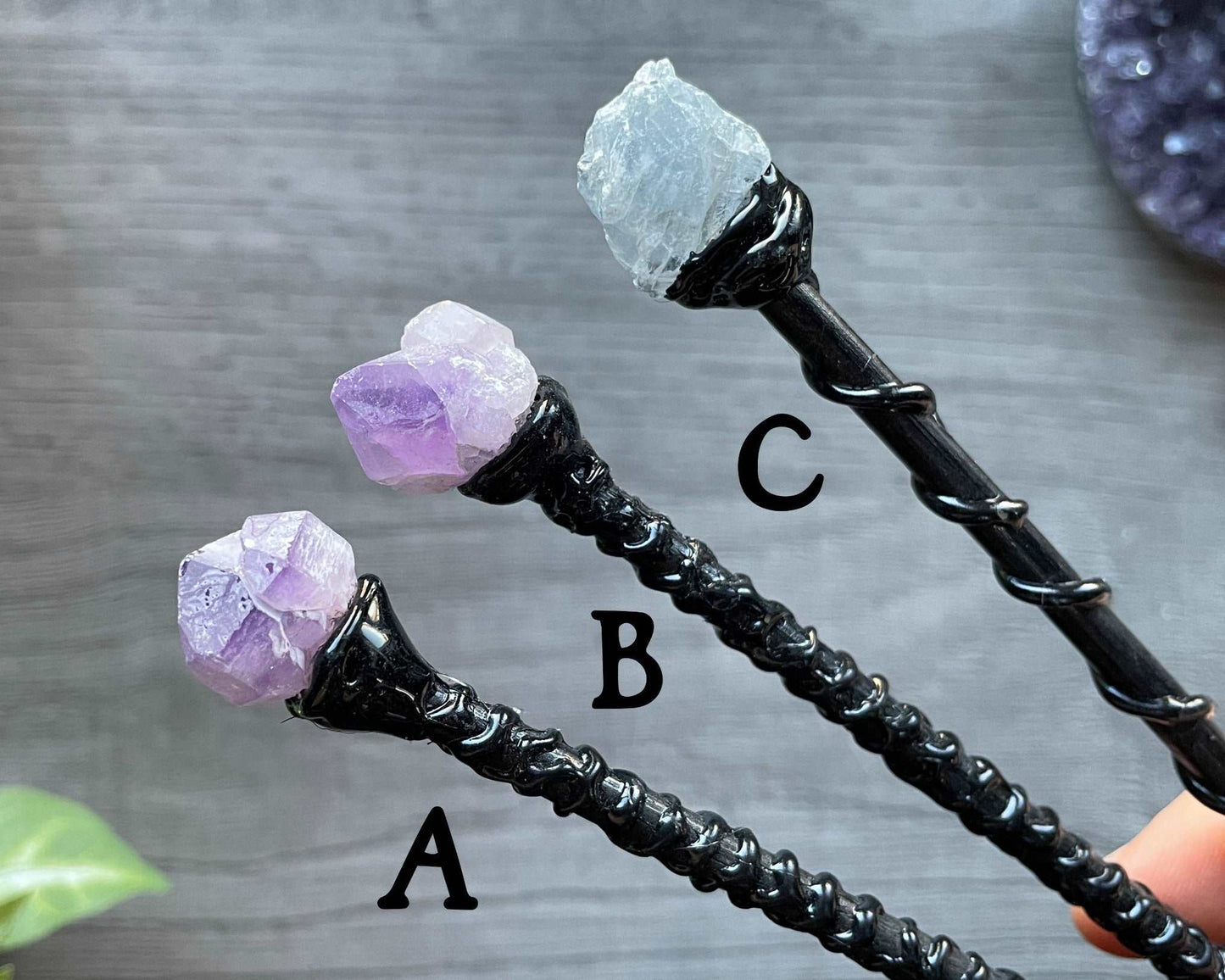 Pictured are various wood wands with crystals on top.