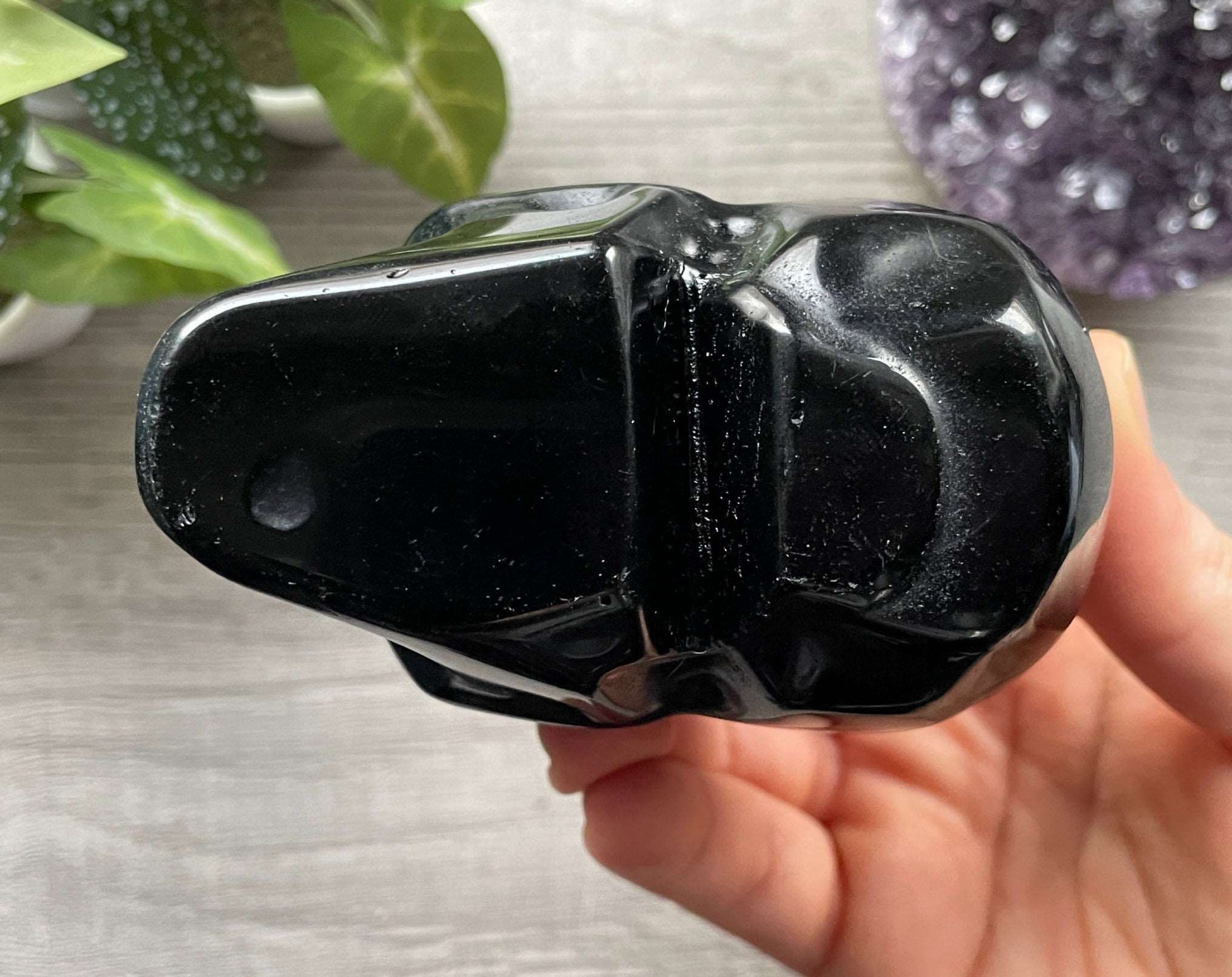 Pictured is a large skull carved out of black obsidian.