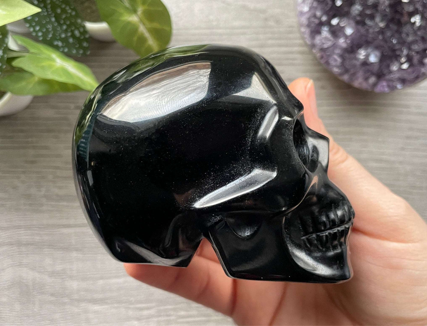 Pictured is a large skull carved out of black obsidian.