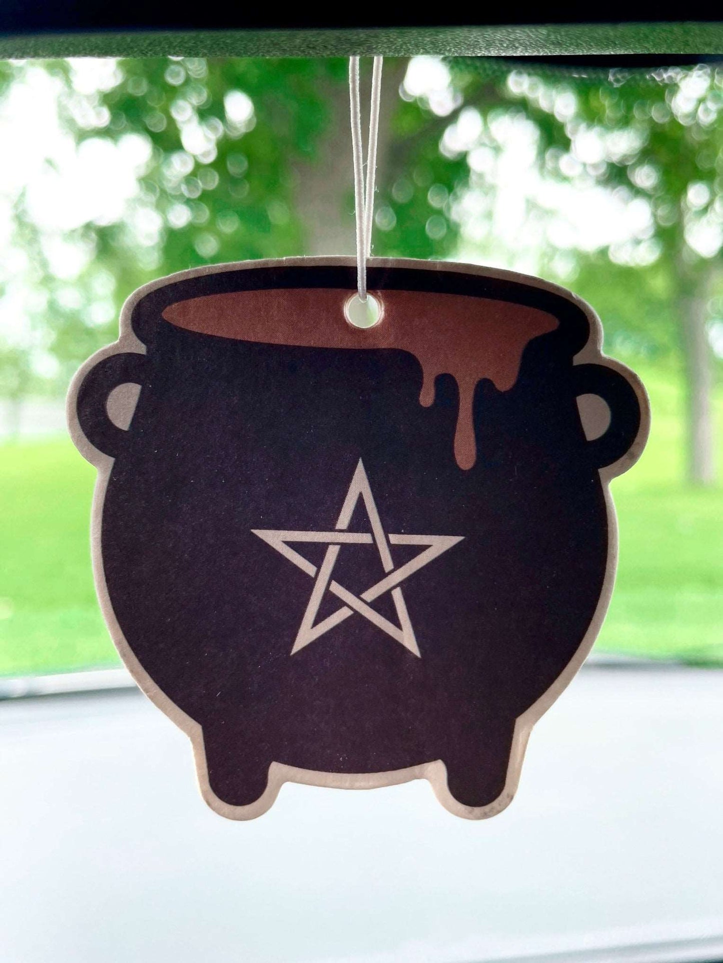Pictured is an air freshener in the shape of a cauldron.