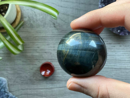 Pictured is a sphere carved out of blue tiger's eye..