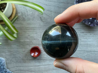 Pictured is a sphere carved out of blue tiger's eye.