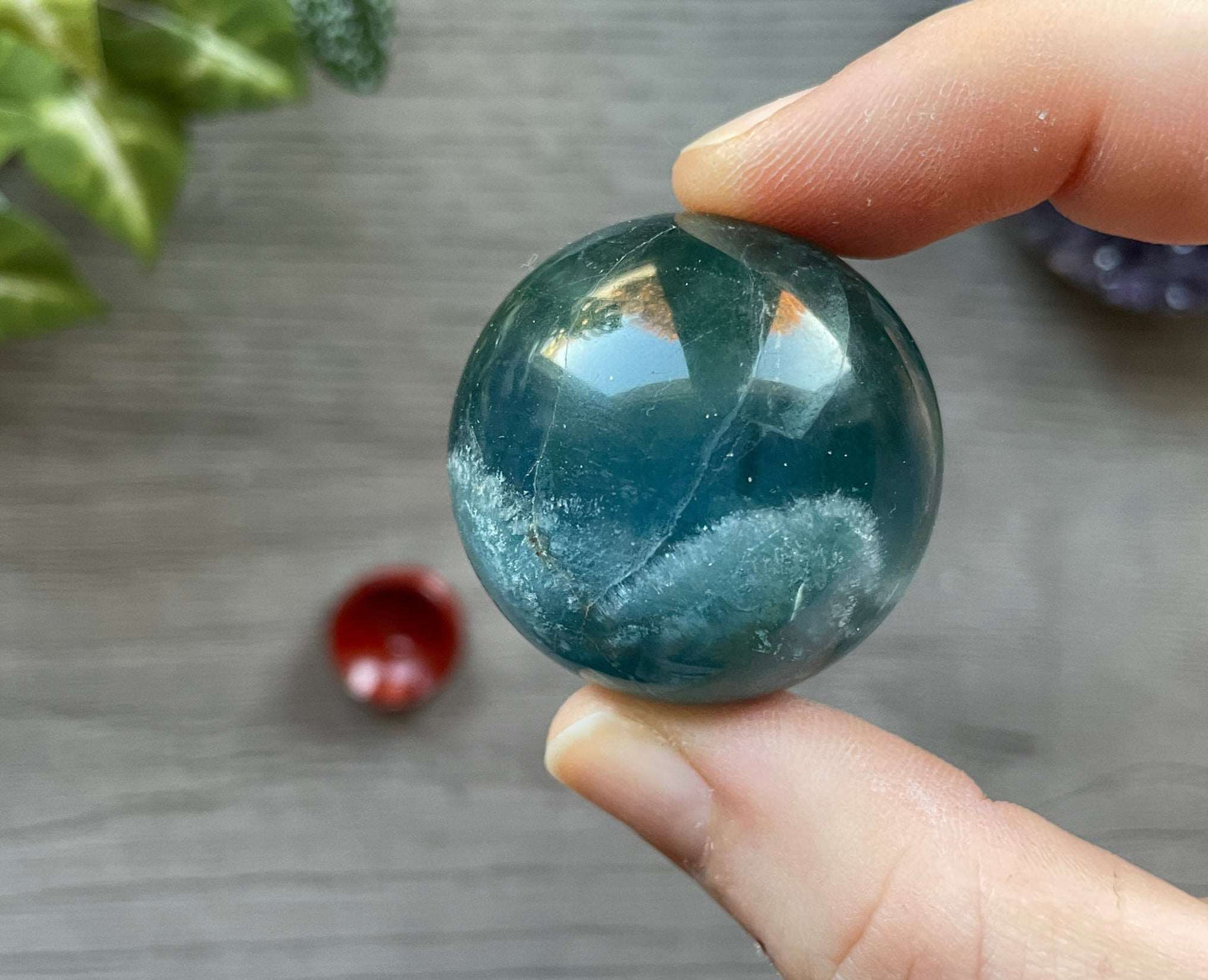 Pictured is a sphere carved out of blue fluorite.