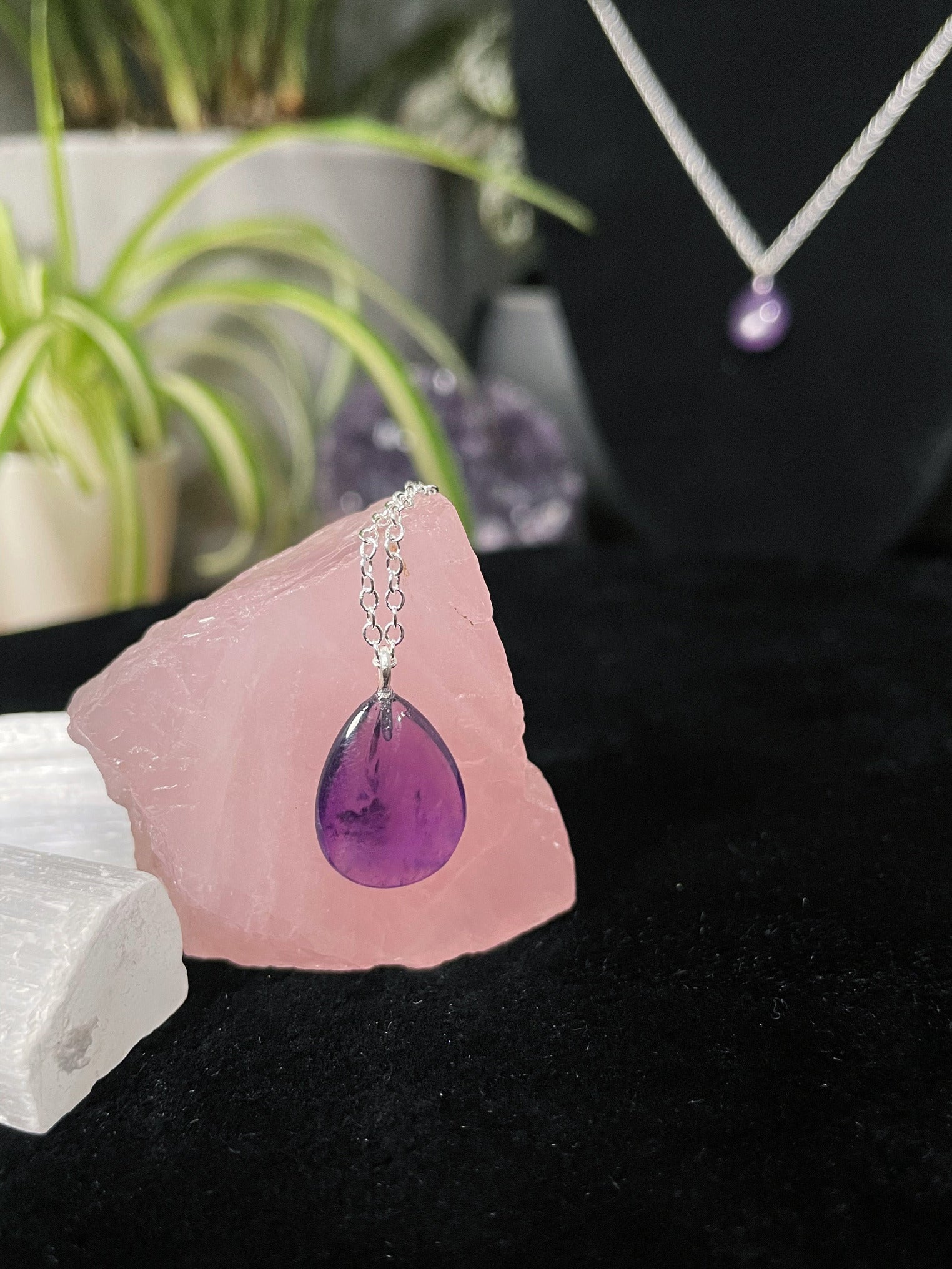 Pictured is a small amethyst teardrop necklace with a silver chain.