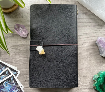 Pictured is a faux leather refillable notebook with a crystal.