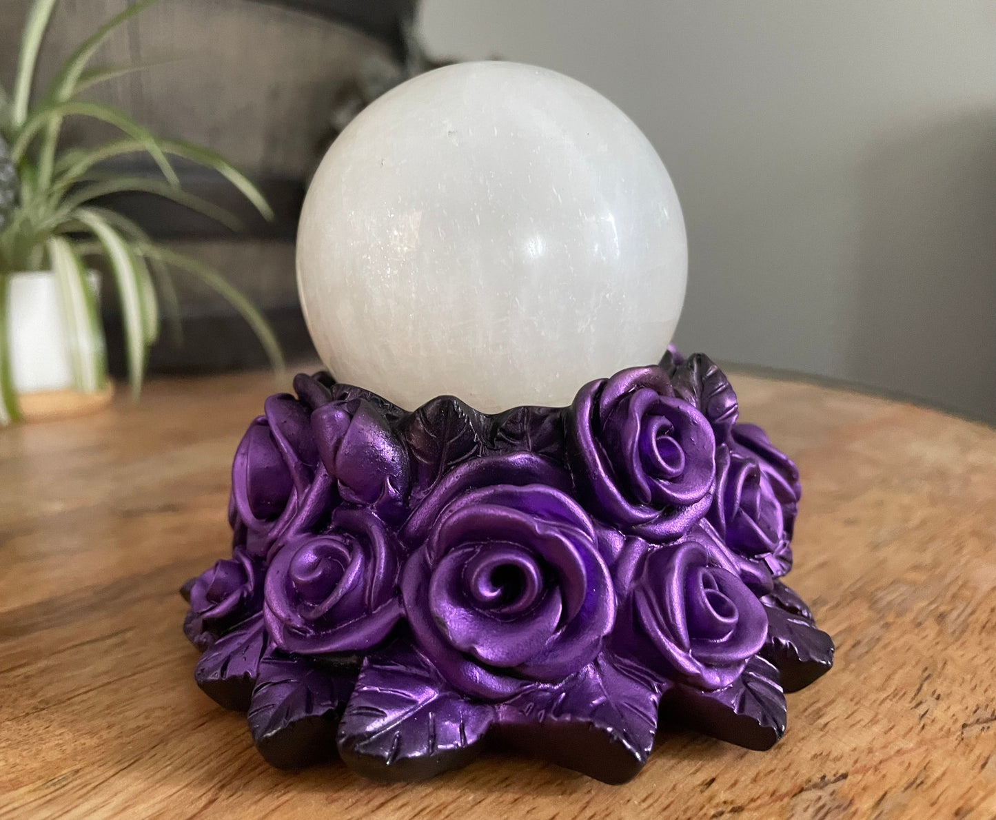 Pictured is a sphere stand in the shape of a bed of purple roses.