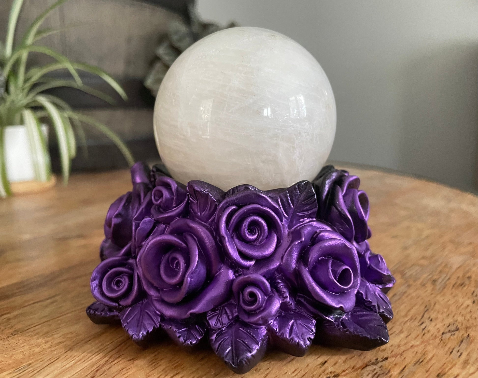 Pictured is a sphere stand in the shape of a bed of purple roses.