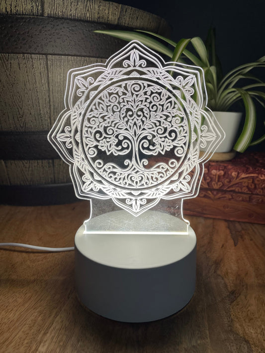 Pictured is a night light with an acrylic tree of life design.